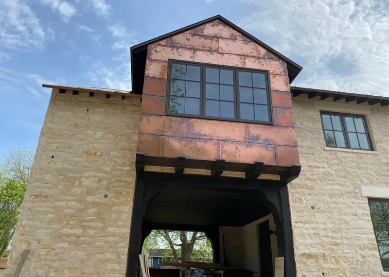 Copper metal panel facade on a stone building for Skylight Installation in Sandy